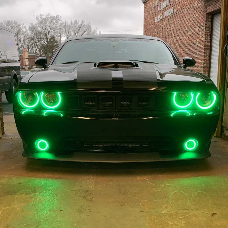 A black sports car with custom green headlights