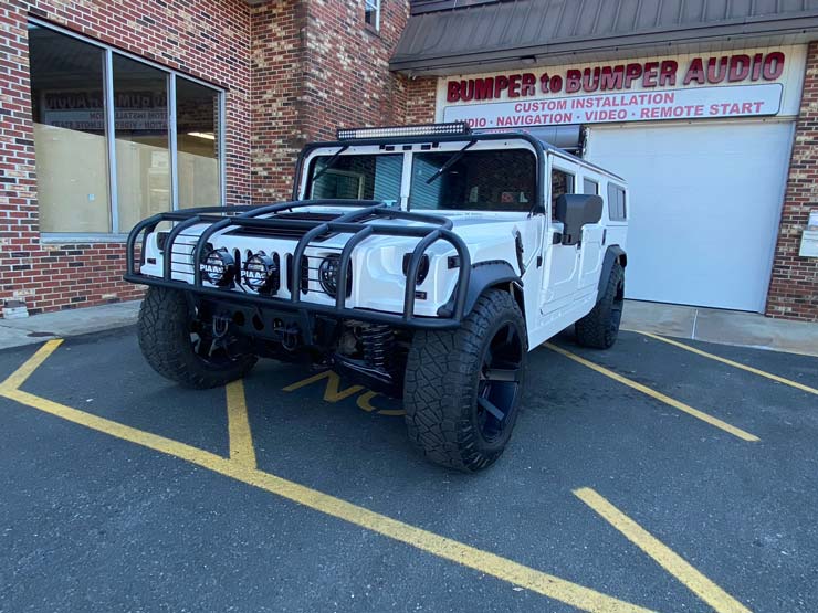 A white Hummer in front of Bumper to Bumper Car Audio